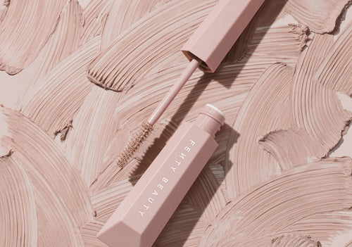 Open shot of Hella Extra Mascara Primer on a product texture background. Open shot of Hella Extra Mascara Primer on a product texture background.