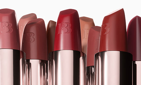 Editorial shot of open Fenty Icon Semi-Matte Lipsticks in a nude case. Editorial shot of open Fenty Icon Semi-Matte Lipsticks in a nude case.