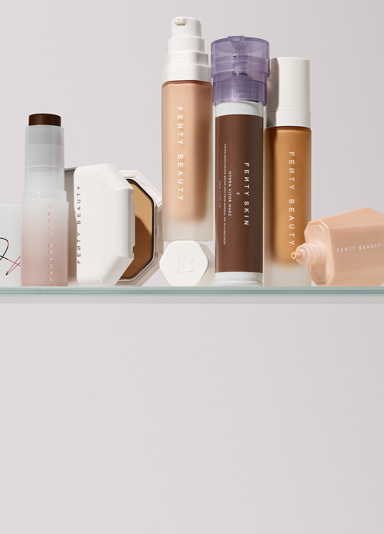 Fenty Beauty complexion collection on a clear shelf.