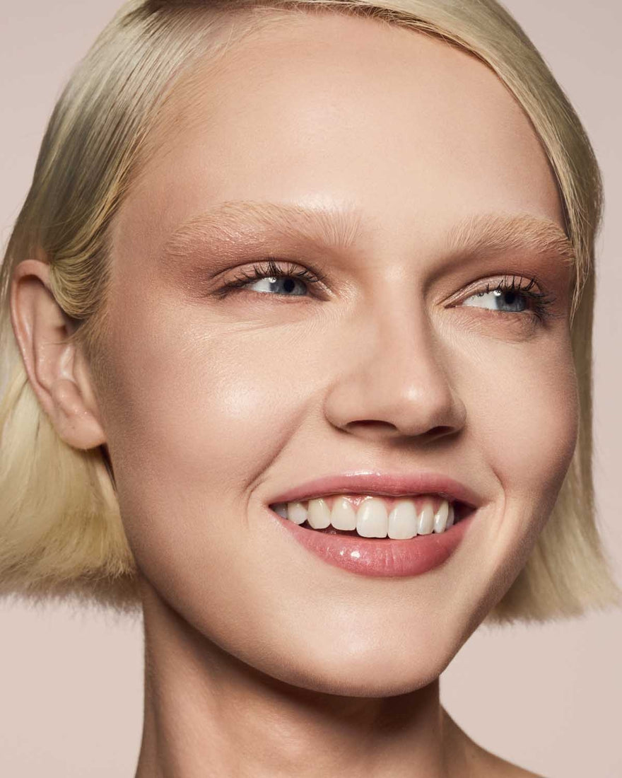 light skin toned model wearing gloss bomb universal lip luminizer in Fu$$y