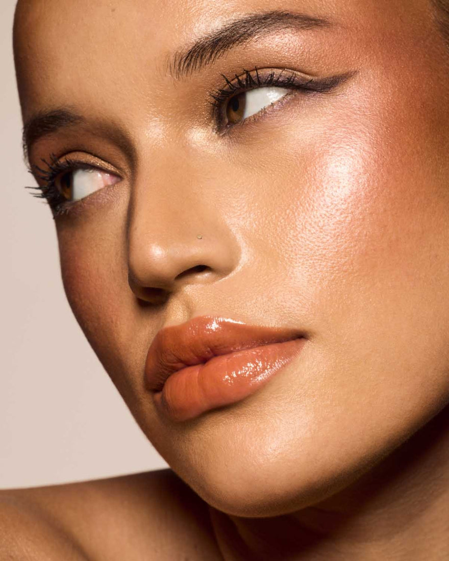 medium skin toned model wearing gloss bomb cream in shade honey waffles