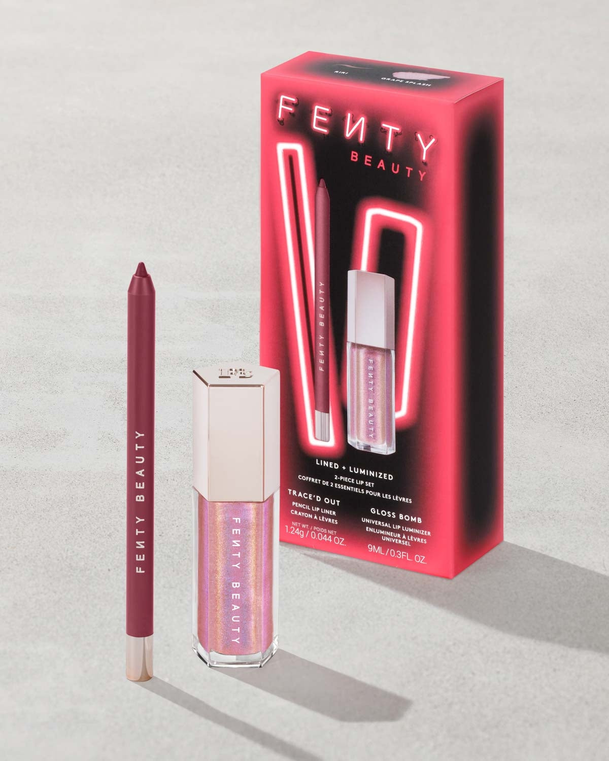 Fenty Beauty lip products including a lip liner and gloss with packaging on a light gray background