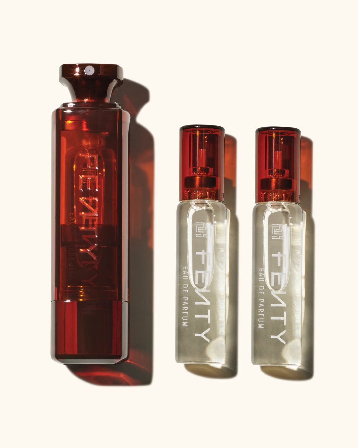 1 travel-size 10ml Fenty bottle placed next to 2 clear bottles for refilling.