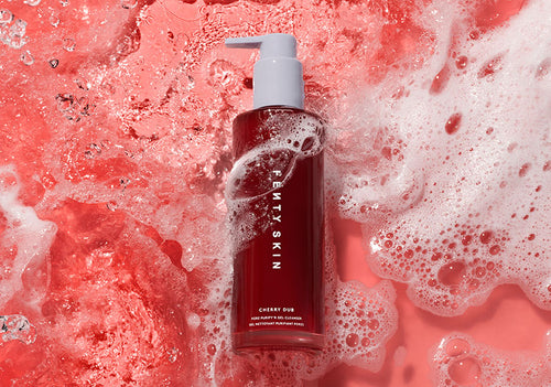Cherry Dub Por Purify Gel Cleanser on a red foamy background.