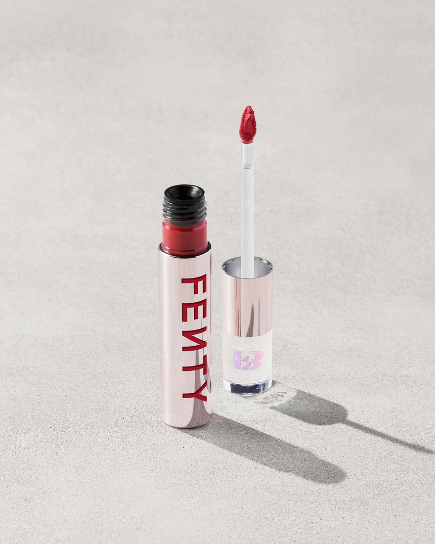 An open Fenty Icon Velvet lipstick tube on a light background.