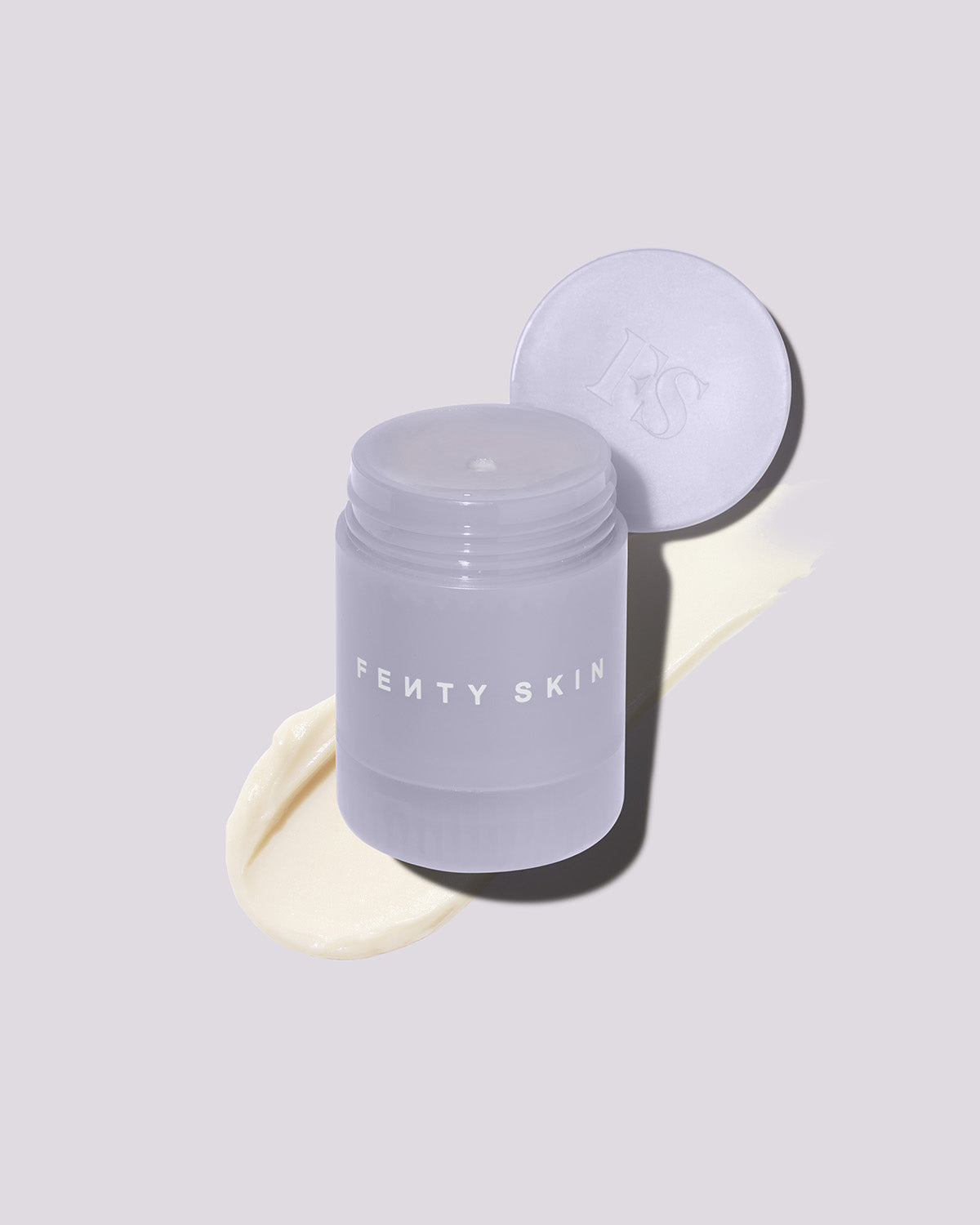 An open container of Thicc N Smooth Rich Peptide eye cream on a lilac background.